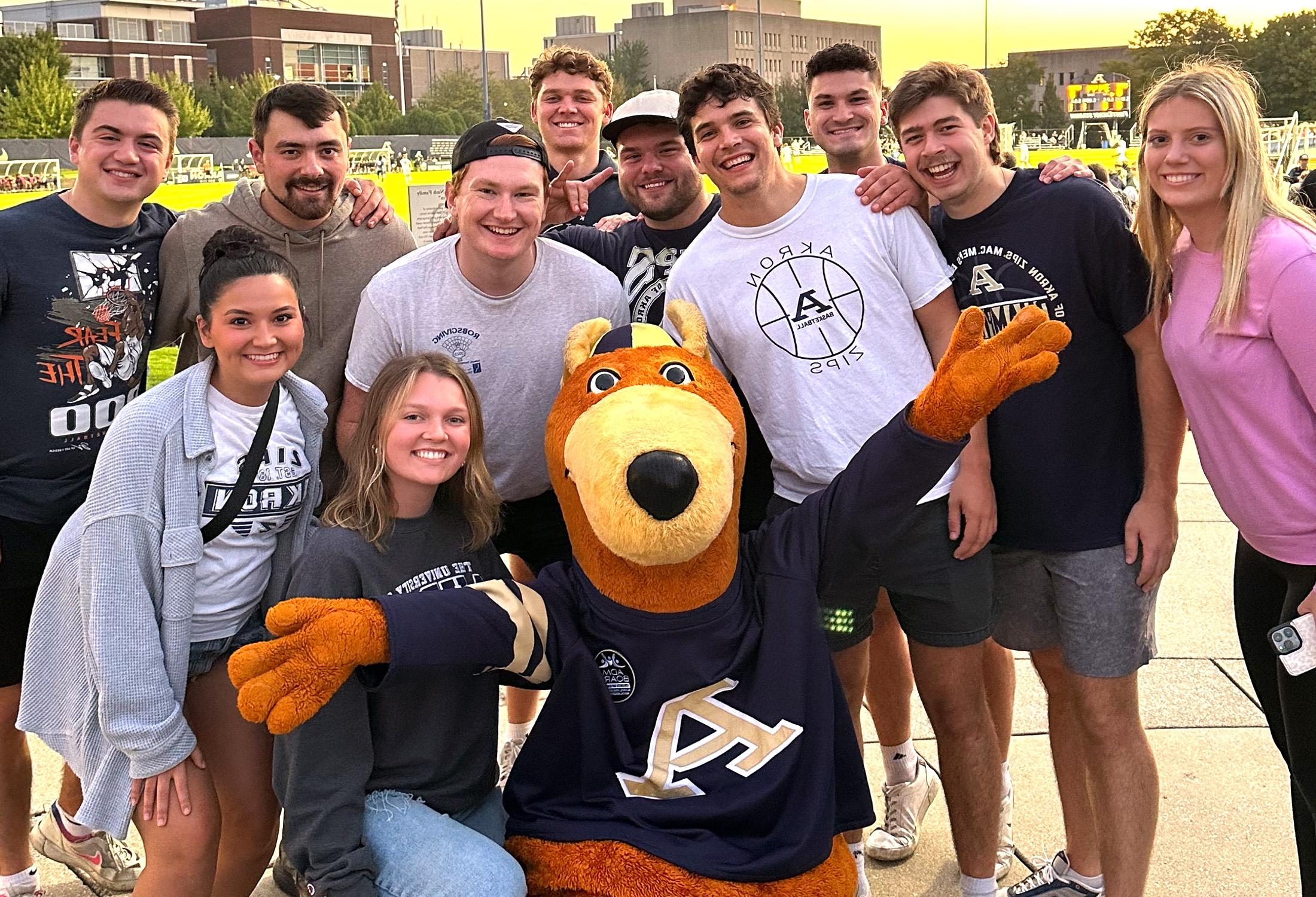 Students on campus taking a picture with Zippy